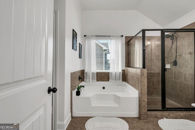 bathroom with tile patterned flooring, independent shower and bath, and lofted ceiling