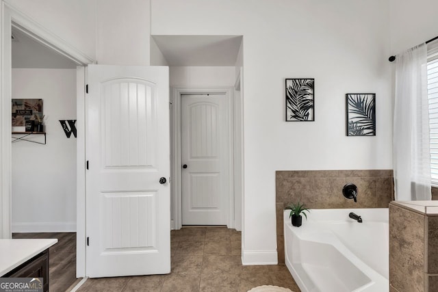 bathroom with vanity, tile patterned floors, and a tub