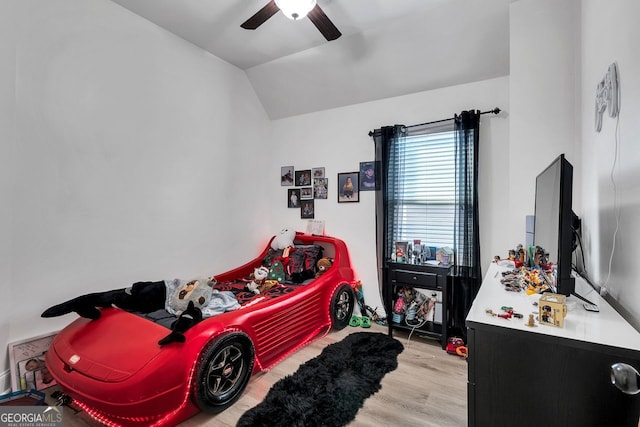 bedroom featuring light wood-type flooring, ceiling fan, and lofted ceiling