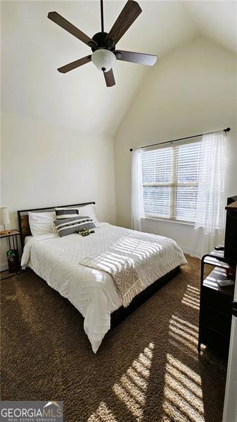 carpeted bedroom featuring ceiling fan and high vaulted ceiling