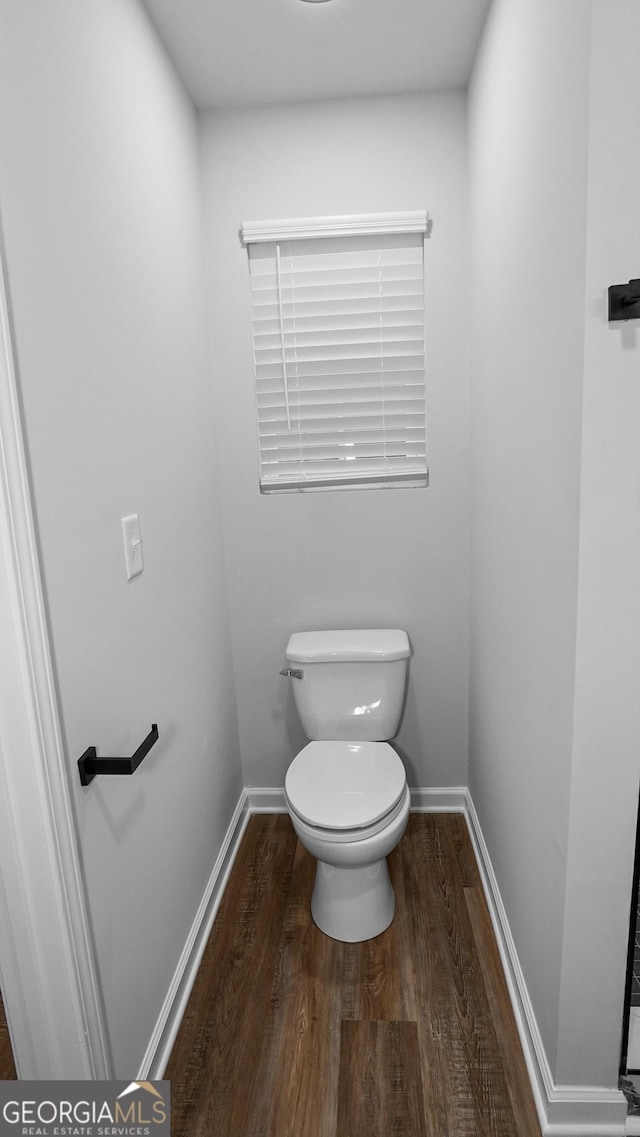 bathroom with hardwood / wood-style floors and toilet