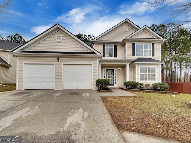 view of property featuring a front yard and a garage