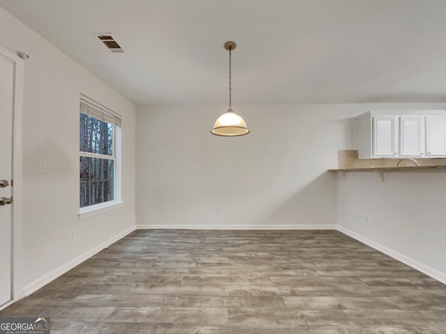 unfurnished dining area with hardwood / wood-style floors