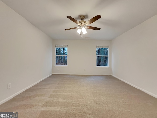 empty room featuring ceiling fan and light colored carpet