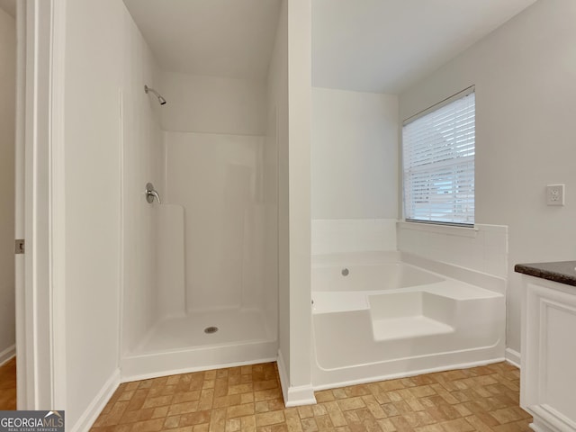 bathroom with vanity and plus walk in shower