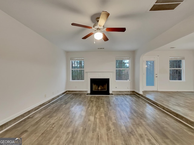 unfurnished living room with hardwood / wood-style floors and ceiling fan