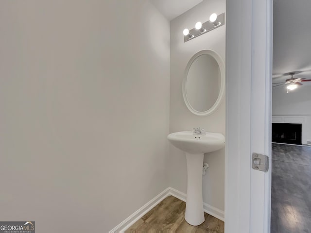 bathroom with ceiling fan and hardwood / wood-style flooring