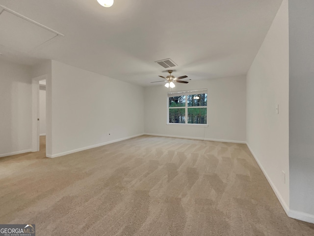 unfurnished room with light colored carpet and ceiling fan