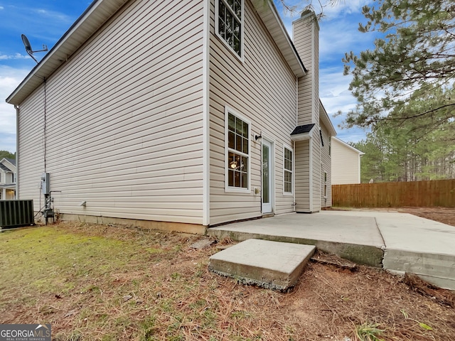 view of home's exterior featuring a lawn, a patio area, and cooling unit