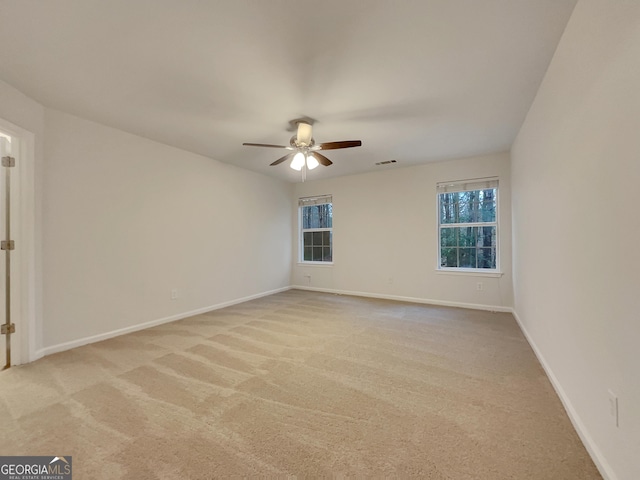 unfurnished room with ceiling fan and light colored carpet