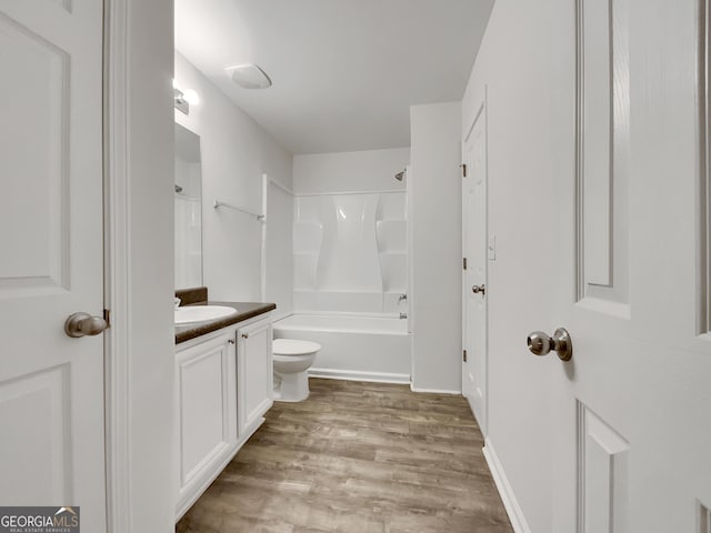 full bathroom with hardwood / wood-style floors, vanity, toilet, and shower / bathtub combination