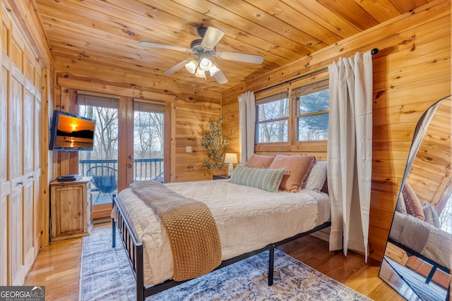 bedroom with access to exterior, ceiling fan, wood ceiling, and light wood-type flooring