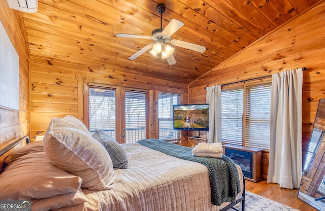 bedroom with wood walls, light wood-type flooring, lofted ceiling, and wooden ceiling