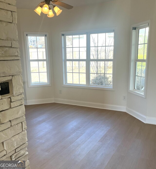 living room with wood-type flooring, a textured ceiling, and ceiling fan