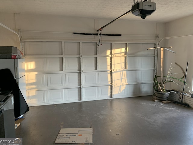 garage featuring a garage door opener and fridge