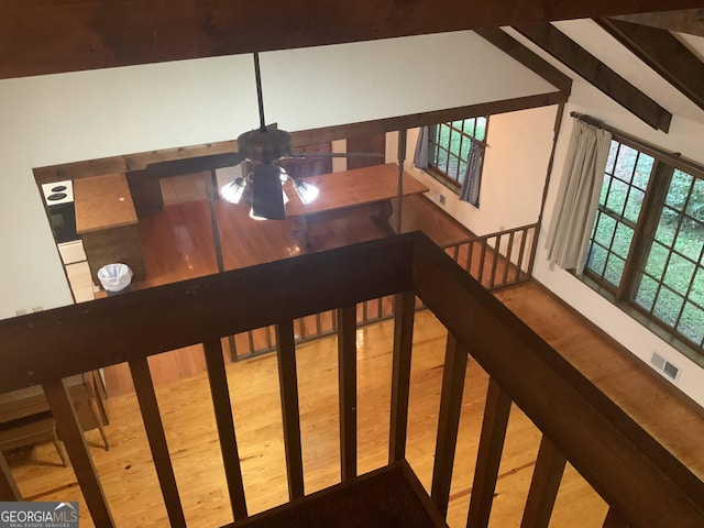 stairs featuring wood-type flooring and ceiling fan