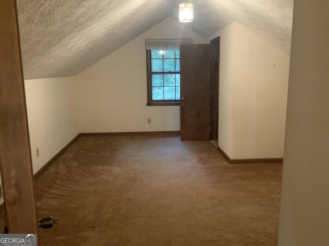 bonus room with a textured ceiling, carpet floors, and lofted ceiling