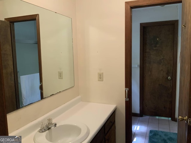 bathroom featuring tile patterned flooring and vanity