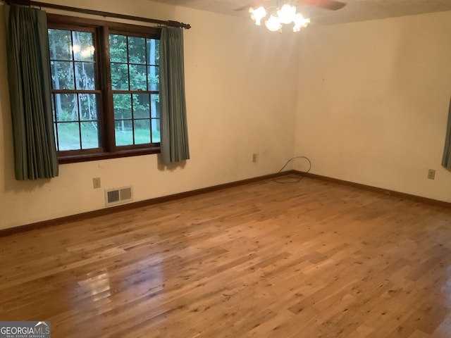 unfurnished room with hardwood / wood-style floors and ceiling fan