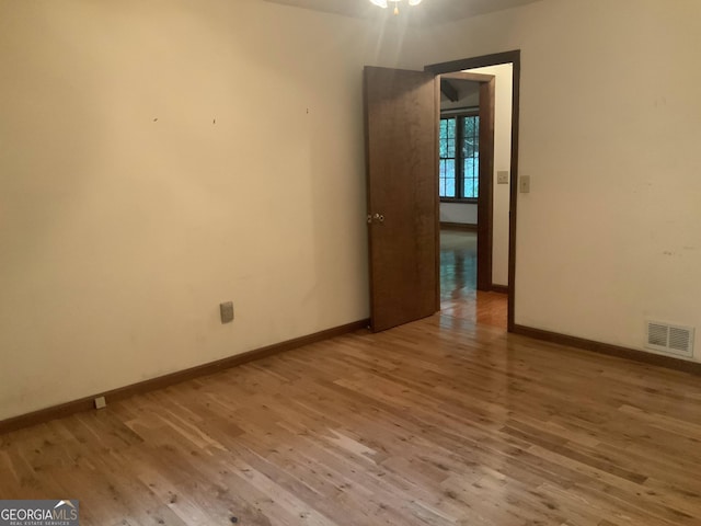 spare room featuring light hardwood / wood-style floors