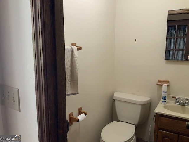 bathroom featuring vanity and toilet