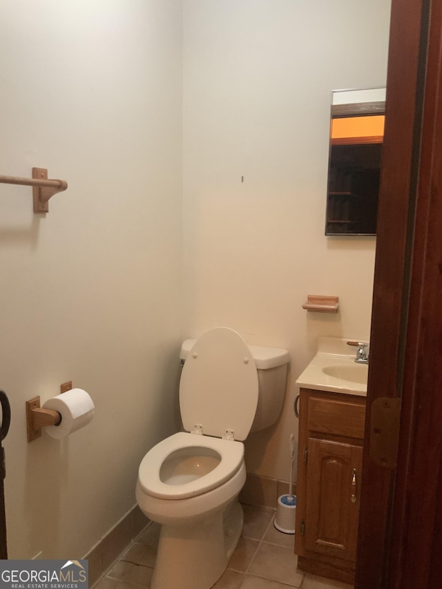 bathroom featuring toilet, vanity, and tile patterned floors