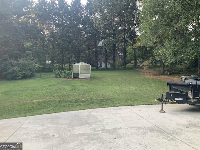 view of yard featuring a patio area and an outbuilding