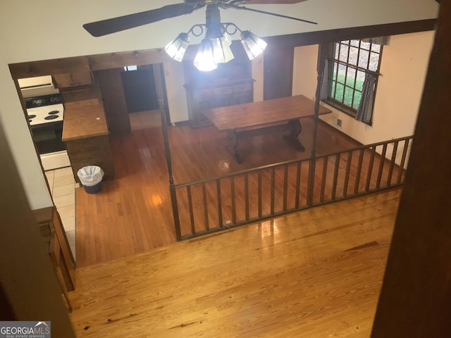 room details featuring ceiling fan, hardwood / wood-style floors, and white range