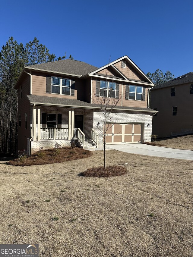 view of front of home with covered porch and a garage