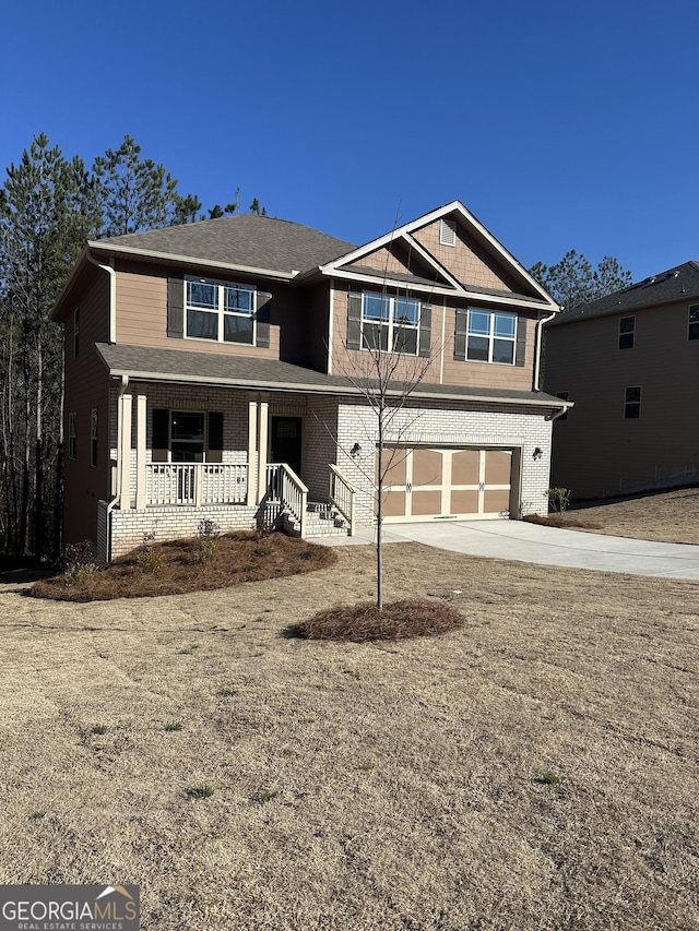 view of front facade with covered porch, concrete driveway, brick siding, and an attached garage