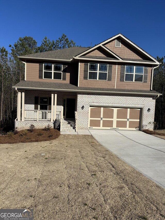 view of front of house featuring covered porch and a garage