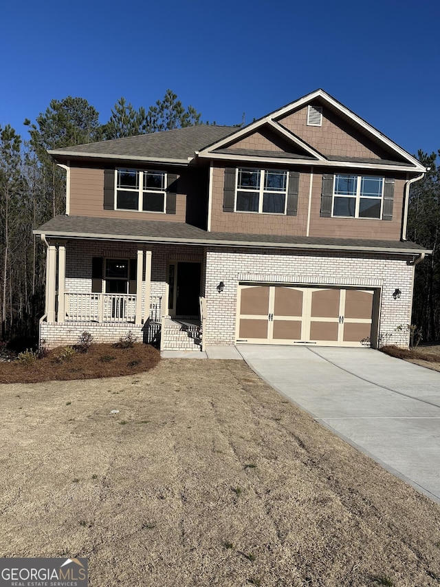 view of front facade with a garage, concrete driveway, brick siding, and a porch