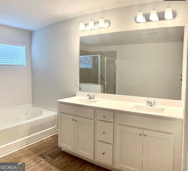 bathroom with vanity, hardwood / wood-style flooring, and separate shower and tub