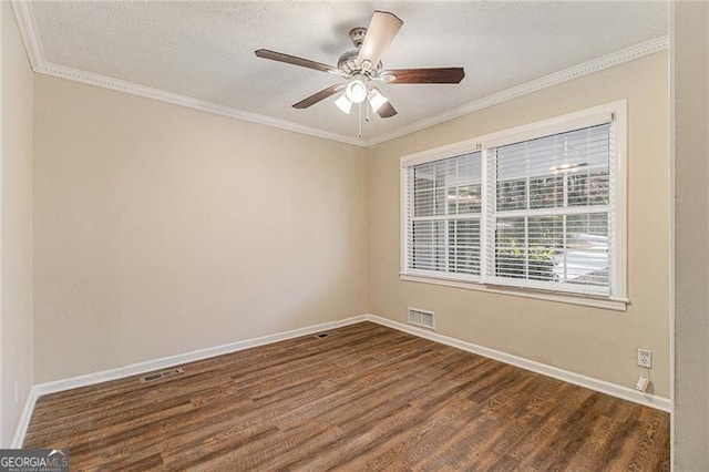 empty room featuring dark hardwood / wood-style floors, ceiling fan, and crown molding