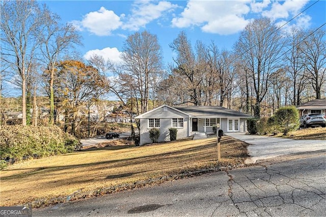 ranch-style home featuring a front yard and a porch