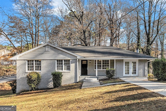 ranch-style home featuring a front lawn, a porch, and french doors