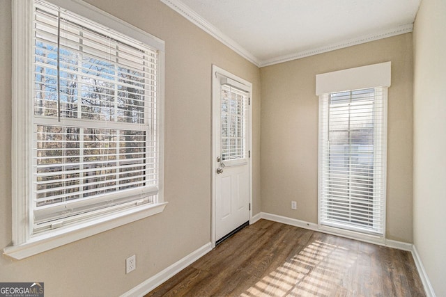 foyer with dark hardwood / wood-style flooring and crown molding