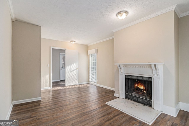 unfurnished living room with dark hardwood / wood-style flooring, a textured ceiling, and ornamental molding