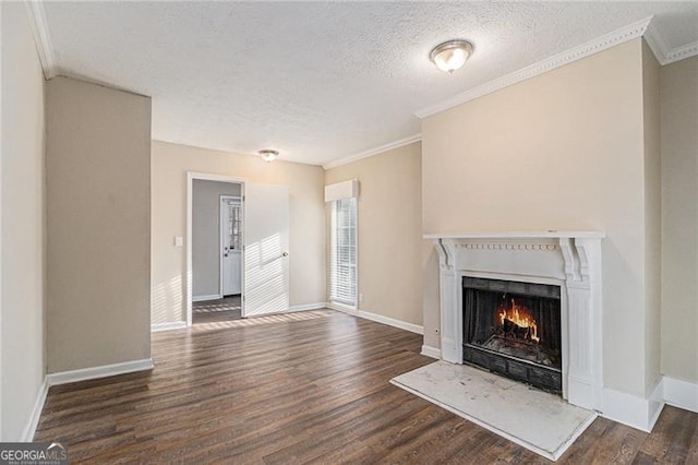 unfurnished living room featuring a textured ceiling, dark hardwood / wood-style flooring, and crown molding