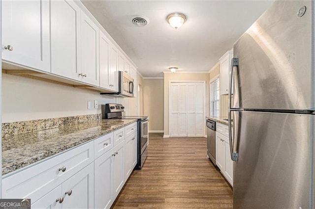 kitchen featuring white cabinetry, stainless steel appliances, and light stone counters