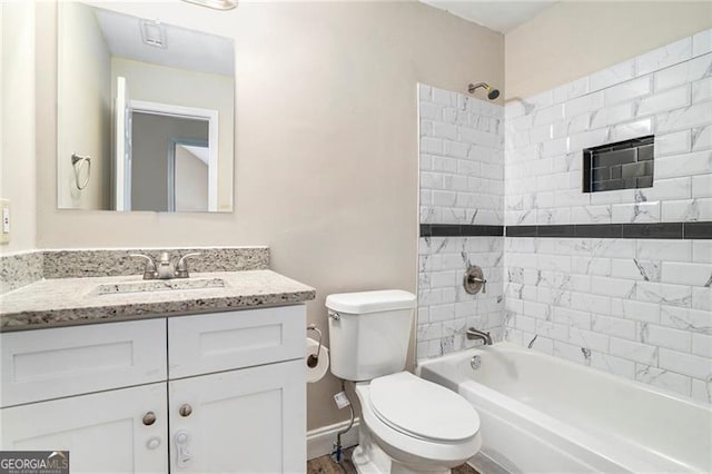 full bathroom with vanity, toilet, and tiled shower / bath