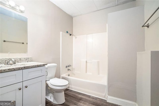 full bathroom featuring hardwood / wood-style floors, vanity, toilet, and bathing tub / shower combination