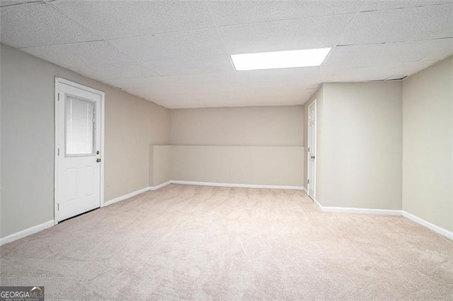 carpeted spare room with a paneled ceiling