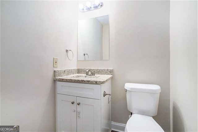 bathroom featuring vanity and toilet