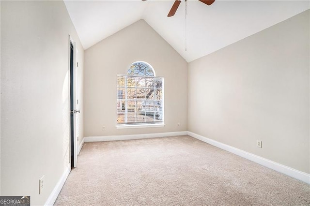 empty room featuring ceiling fan, light colored carpet, and lofted ceiling