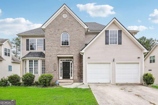 view of property featuring a front lawn and a garage