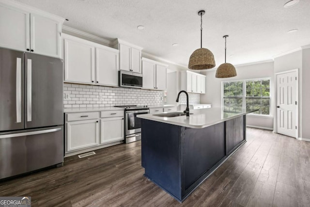 kitchen with sink, white cabinets, decorative light fixtures, and appliances with stainless steel finishes