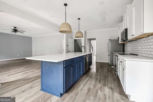 kitchen featuring white cabinetry, a large island, blue cabinets, pendant lighting, and appliances with stainless steel finishes