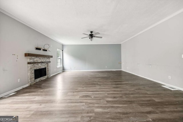 unfurnished living room featuring a textured ceiling, ceiling fan, crown molding, a fireplace, and dark hardwood / wood-style floors