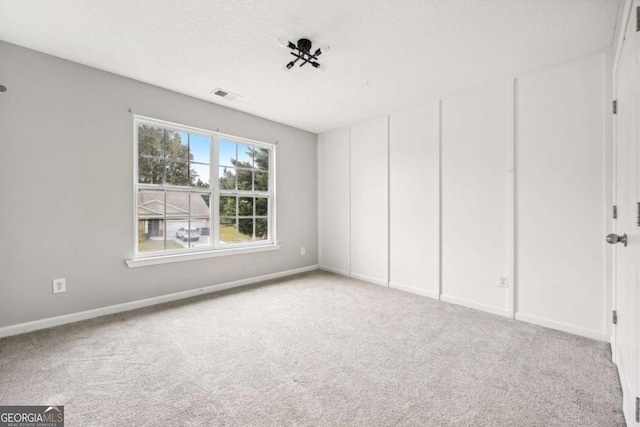 unfurnished bedroom with light colored carpet